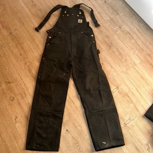 Black Carhartt overalls.